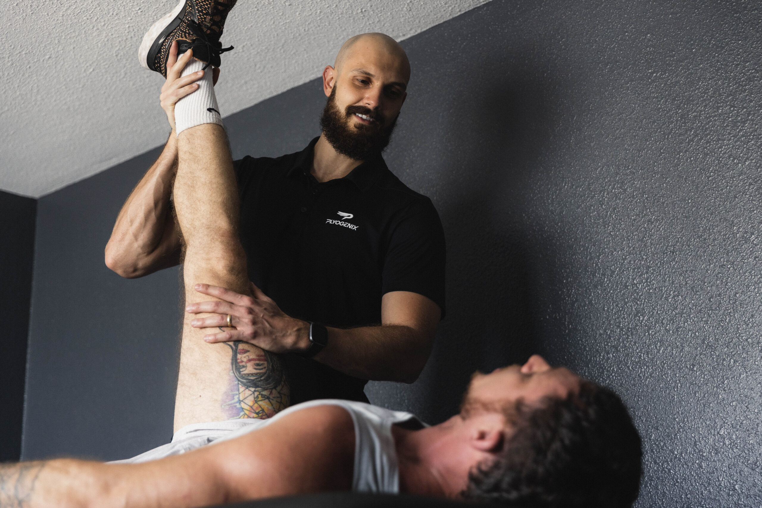 dr mitko working with stretching a clients leg during physical therapy